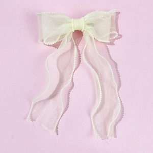 Elegant off-white organza bow hair clip with decorative pearl edges on pink background