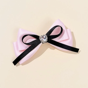 Pink and black ribbon bow hair clip with a sparkling heart-shaped crystal center