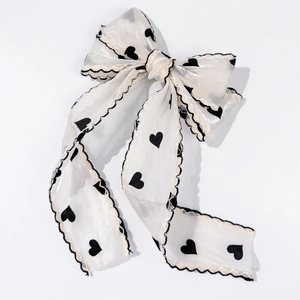 Elegant white mesh bow hair clip with black heart print and delicate wavy edges
