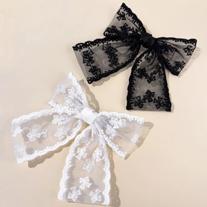 Elegant large lace bow hair clips in black and white with delicate eyelash mesh detail