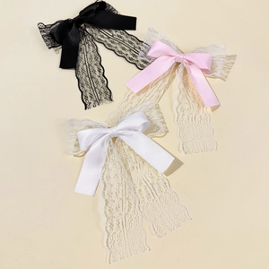 Elegant lace bow hair clips in black, white, and pink with long flowing ribbon streamers
