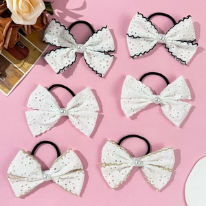 Set of 6 lace bow hair ties with pearls and embroidery on a pink background