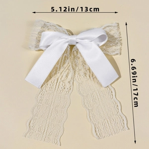 Detailed view of white lace and satin bow hair clip with ribbons and size measurements