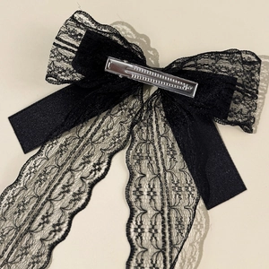 Close-up of the black lace bow hair clip featuring a durable silver metal alligator clip