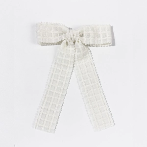 Elegant cream-white bow hair clip with textured fabric and scalloped edges for women