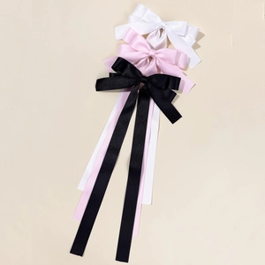 Elegant long ribbon bow hair clips in white, pink, and black satin fabric for women