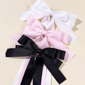 Three elegant satin bow hair clips with long ribbons in white pink and black