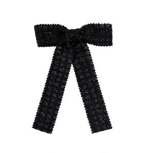 Elegant black bow hair clip with shimmering honeycomb texture and long ribbon tails