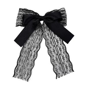 Elegant black lace and satin bow hair clip with long ribbons on a clean white background