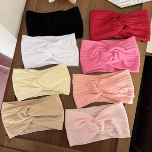 Eight pack of colorful knitted twist baby headbands featuring a soft elastic braided design