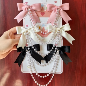 Roze witte en zwarte strik haarclips met lange parelkwasten en elegante satijnen stof