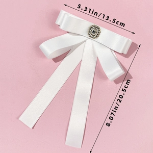Detailed size specifications of white satin bow brooch with crystal center embellishment