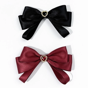 Elegant bow tie pins in black and burgundy satin with heart-shaped crystal centerpieces