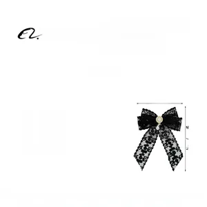 Detail of elegant black lace bow hair clip featuring a central pearl and diamond accent