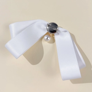 Elegant white satin bow brooch with pearl pendant and secure silver metal pin back