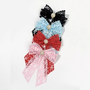 Detailed macro view of lace bow hair clips with pearls and rhinestones in multiple colors