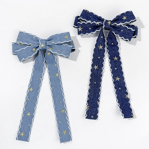 Vintage denim bow hair clips with gold star patterns and wavy white lace ribbons