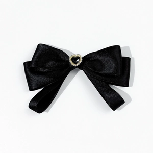Detail of black satin bow with crystal heart centerpiece for shirt collar or hair