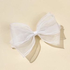 Detail of multi-layer white mesh bow hair clip with translucent organza texture