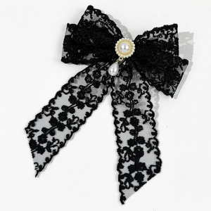 Detail of black lace bow hair clip with center faux pearl and teardrop pearl pendant