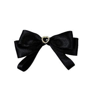 Elegant black satin bow tie with a heart-shaped rhinestone center on white background