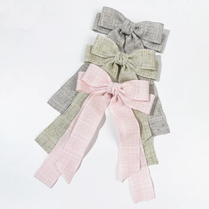 Elegant large fabric bow hair clips with long ribbons in grey, beige, and pink colors