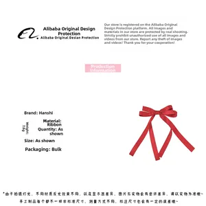 Close-up of lightweight red ribbon bow hair clip with soft silky fabric texture