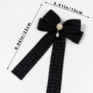 Detail of tweed bow hair clip with lace trim and vintage hanging teardrop pearl