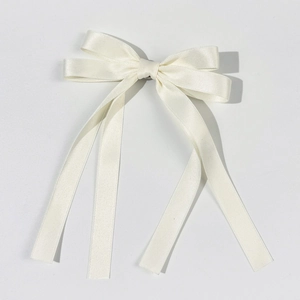 Detailed view of the smooth white satin texture on the elegant ballet bow hair clip