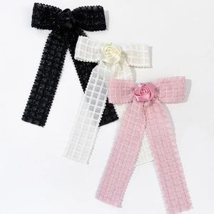 Elegant bow hair clips with rose decor in black, cream, and pink with long ribbons