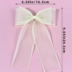 Detail showing the 16.5cm width and 24.5cm length dimensions of the cream tulle hair bow