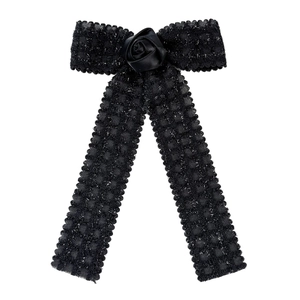 Elegant black bow hair clip with textured ribbon and a satin rose flower detail
