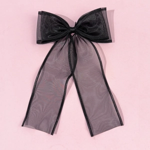 Detail view of the black gauze mesh bow hairpin showing elegant translucent texture