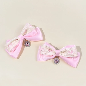 Pink satin bow hair clips with white lace trim and sparkling heart crystal pendants