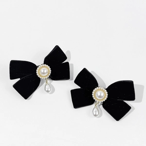 Pair of vintage black velvet bow hair clips with pearls in an elegant Hepburn style