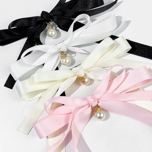 Elegant satin bow hair clips with pearls in black, white, cream, and pink colors
