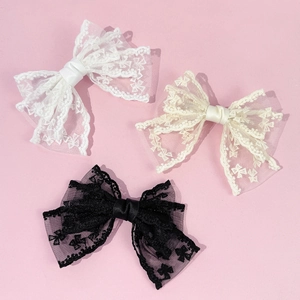 Large lace bow hair clips set in black, white and beige colors for elegant styling