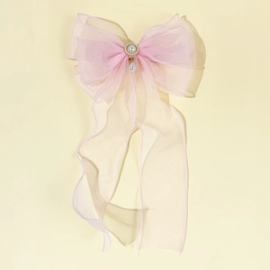 Elegant pink gradient mesh bow hair clip with pearl tassels and central circular embellishment