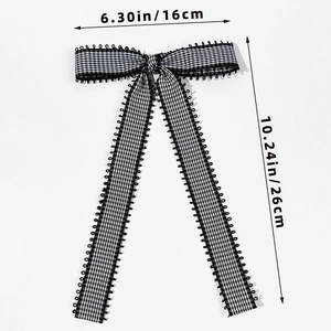 Detailed size view of black and white gingham bow hair clip with lace trim edges
