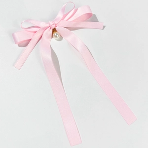 Elegant pink satin bow hair clip with a gold ring and white pearl pendant drop