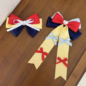 Handmade Snow White style bow hair clips with satin ribbons and heart charms on wood