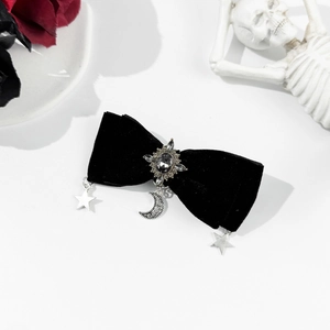 Gothic black velvet bow hair clip with silver star and moon pendants on white background
