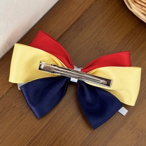 Sweet Snow White style bow hair clip with red yellow and navy satin ribbons