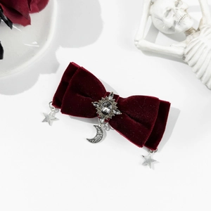 Gothic wine red velvet bow hair clip with silver star and moon charms on white background
