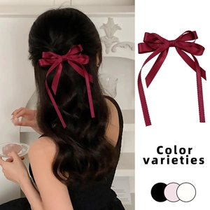 Elegant wine red ribbon bow hair clip in satin fabric with classic long tail streamers