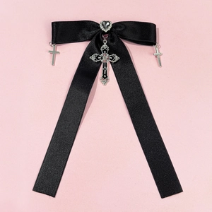 Detail of Gothic black satin bow hair clip with silver heart gemstone and cross charms