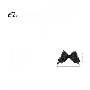 Detail of elegant black ribbon and mesh bow hair clip with lace edges for women