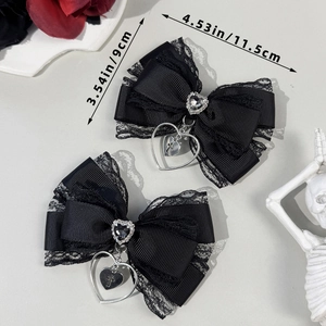 Detailed view of Gothic black lace bow hair clips with heart rhinestone and cross pendant