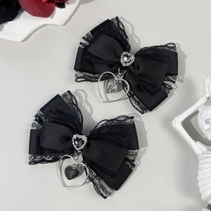 Gothic style black lace bow hair clips with silver cross heart pendants macro view