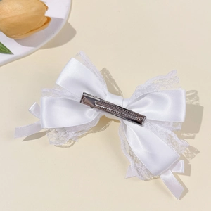 Elegant white lace ribbon bow hair clip with satin layers and a vintage princess style